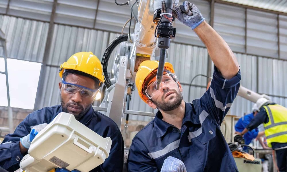 maintenance-engineer-repair-and-programing-robotic-arm-in-factory-industry-robot-service-shop-1.jpg